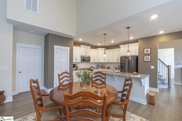 101 Greensdale Ln, Easley, SC 29642 - dining area featuring baseboards, dark wood-style flooring, stairway, and recessed lighting