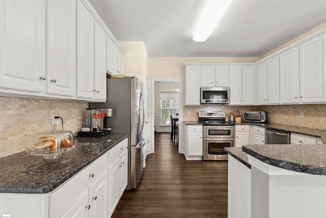 105 Franklin Meadow Way, Greer, SC 29651 - kitchen featuring appliances with stainless steel finishes, white cabinets, dark wood-type flooring, decorative backsplash, and dark stone countertops