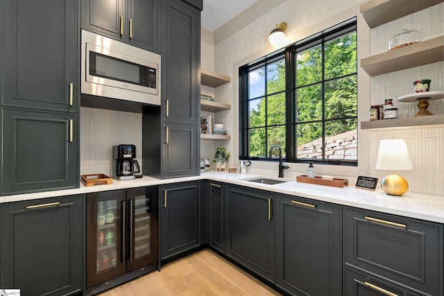 189 Crowne Hill Way, Marietta, SC 29661 - kitchen featuring open shelves, beverage cooler, stainless steel microwave, a sink, and decorative backsplash