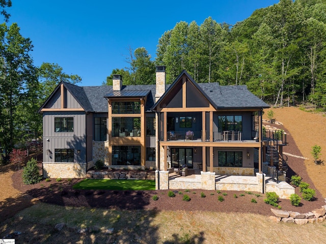 189 Crowne Hill Way, Marietta, SC 29661 - rear view of house with board and batten siding, a patio area, a chimney, stone siding, and stairs