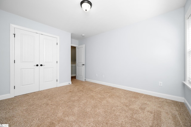 216 Country Gln, Pelzer, SC 29669 - unfurnished bedroom featuring carpet floors, a closet, and baseboards