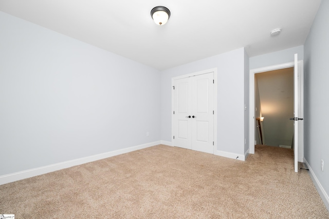 216 Country Gln, Pelzer, SC 29669 - unfurnished bedroom featuring light carpet, baseboards, and a closet