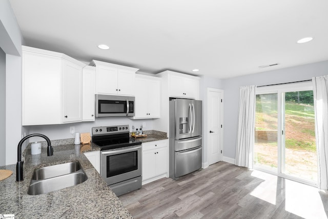 216 Country Gln, Pelzer, SC 29669 - kitchen featuring stainless steel appliances, a sink, recessed lighting, white cabinets, and dark stone countertops