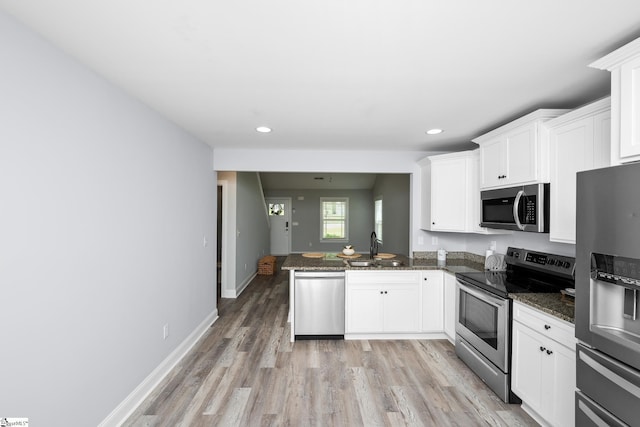 216 Country Gln, Pelzer, SC 29669 - kitchen with appliances with stainless steel finishes, a sink, white cabinets, light wood-style floors, and recessed lighting