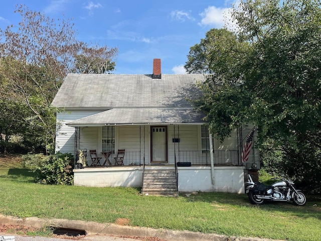 8 Sue Cleveland School Rd, Piedmont, SC 29673 - view of front of house with covered porch, a front yard, a shingled roof, and a chimney