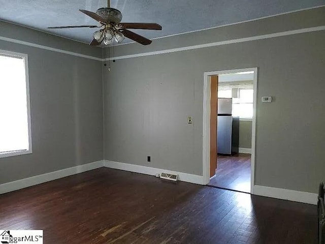 8 Sue Cleveland School Rd, Piedmont, SC 29673 - empty room with dark wood-type flooring, ceiling fan, and baseboards