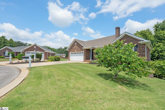 14 Saint Thomas Ct, Greer, SC 29651 - view of front facade with brick siding, driveway, a chimney, and an attached garage