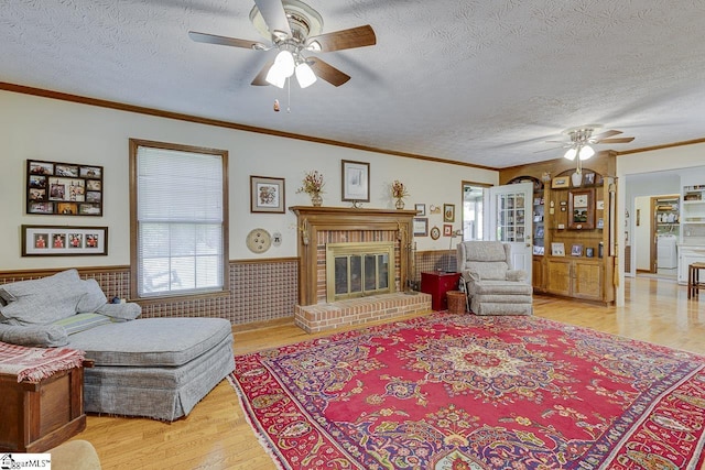 101 N Lady Slipper Ln, Greer, SC 29650 - living area with a ceiling fan, plenty of natural light, light wood finished floors, a wainscoted wall, and a textured ceiling
