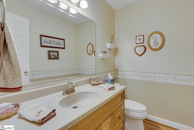 101 N Lady Slipper Ln, Greer, SC 29650 - half bathroom with vanity, toilet, and wood finished floors