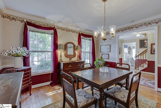 101 N Lady Slipper Ln, Greer, SC 29650 - dining space with plenty of natural light, light wood-style floors, ornamental molding, and a chandelier