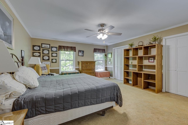 101 N Lady Slipper Ln, Greer, SC 29650 - bedroom with two closets, light colored carpet, crown molding, and ceiling fan