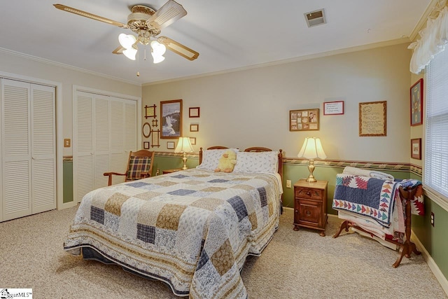 101 N Lady Slipper Ln, Greer, SC 29650 - carpeted bedroom featuring multiple closets, ornamental molding, baseboards, and a ceiling fan