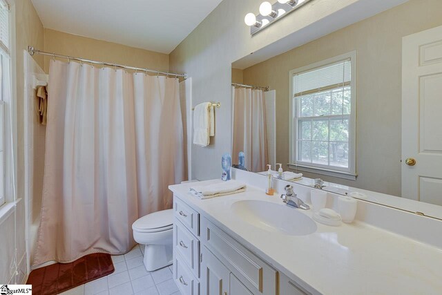 101 N Lady Slipper Ln, Greer, SC 29650 - full bathroom featuring vanity, tile patterned floors, toilet, and shower / bath combo with shower curtain