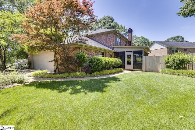 101 N Lady Slipper Ln, Greer, SC 29650 - view of front facade with a chimney, brick siding, a garage, and a sunroom