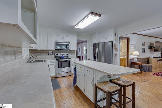 101 N Lady Slipper Ln, Greer, SC 29650 - kitchen with stainless steel appliances, a sink, crown molding, white cabinets, and light countertops