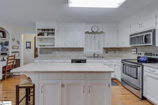 101 N Lady Slipper Ln, Greer, SC 29650 - kitchen with appliances with stainless steel finishes, open shelves, light countertops, white cabinetry, and ornamental molding