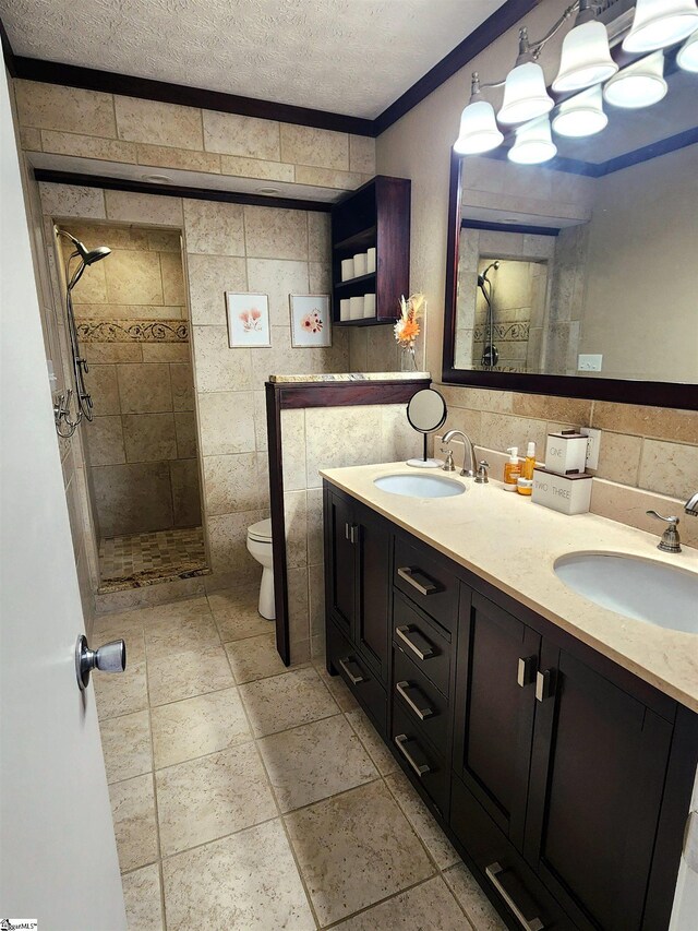 1104 Robert P Jeanes Rd, Easley, SC 29640 - bathroom with tile walls, double vanity, toilet, a shower stall, and a textured ceiling