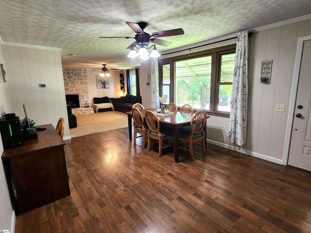 1104 Robert P Jeanes Rd, Easley, SC 29640 - dining space featuring dark wood-style floors, a ceiling fan, a fireplace, a textured ceiling, and baseboards