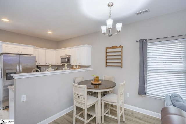 317 Saluda St, Belton, SC 29627 - dining space with light wood-style flooring, baseboards, a chandelier, and recessed lighting