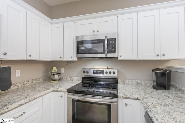 317 Saluda St, Belton, SC 29627 - kitchen with stainless steel appliances, white cabinetry, and light stone counters
