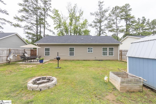 317 Saluda St, Belton, SC 29627 - back of house with an outdoor fire pit, a patio, and a vegetable garden
