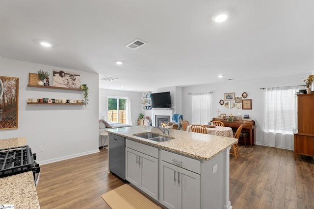 206 Bonifay Dr, Fountain Inn, SC 29644 - kitchen with dishwasher, a sink, a glass covered fireplace, dark wood finished floors, and recessed lighting