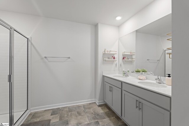 206 Bonifay Dr, Fountain Inn, SC 29644 - bathroom with double vanity, a shower stall, baseboards, and stone finish floors