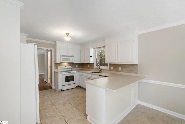 28 Bernwood Dr, Taylors, SC 29687 - kitchen featuring white appliances, decorative backsplash, a peninsula, a sink, and white cabinetry