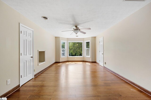 28 Bernwood Dr, Taylors, SC 29687 - empty room featuring ceiling fan, hardwood / wood-style flooring, baseboards, and a textured ceiling