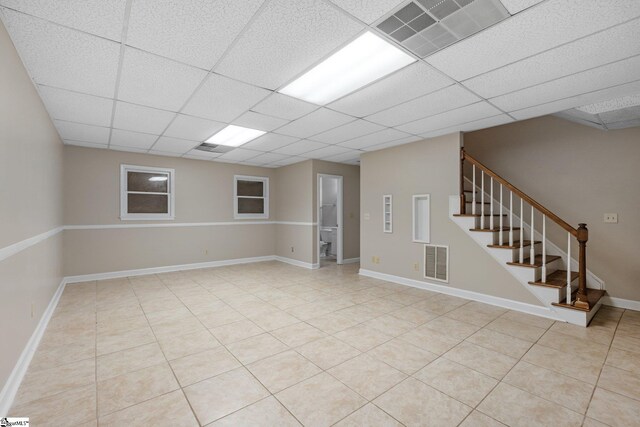 28 Bernwood Dr, Taylors, SC 29687 - unfurnished room with a drop ceiling, stairs, light tile patterned floors, and baseboards