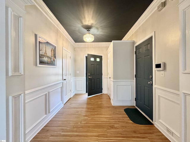 200 Odie Dr, Simpsonville, SC 29681 - foyer entrance with a decorative wall, ornamental molding, light wood-style floors, and a wainscoted wall
