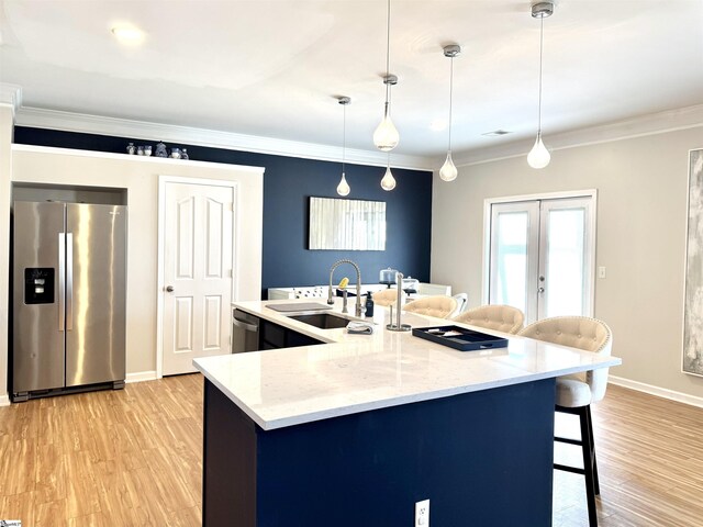 200 Odie Dr, Simpsonville, SC 29681 - kitchen featuring stainless steel appliances, a sink, light wood-style flooring, a kitchen breakfast bar, and french doors