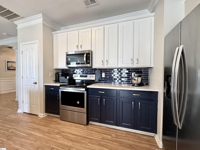 200 Odie Dr, Simpsonville, SC 29681 - kitchen with appliances with stainless steel finishes, ornamental molding, white cabinetry, tasteful backsplash, and light countertops