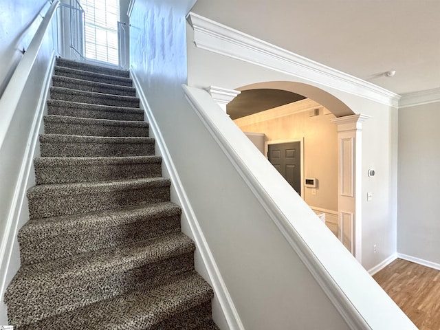 200 Odie Dr, Simpsonville, SC 29681 - staircase with arched walkways, ornamental molding, wood finished floors, and baseboards