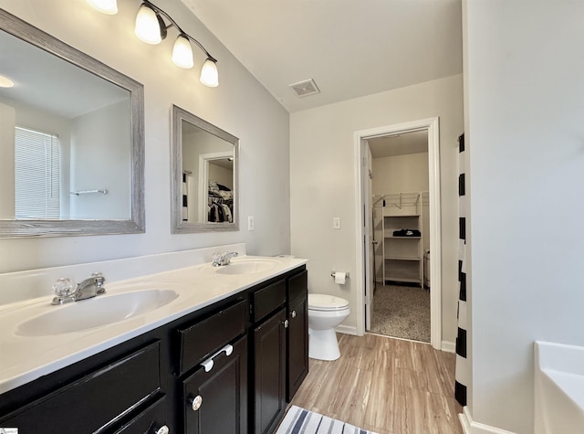200 Odie Dr, Simpsonville, SC 29681 - full bathroom featuring toilet, a walk in closet, double vanity, and baseboards