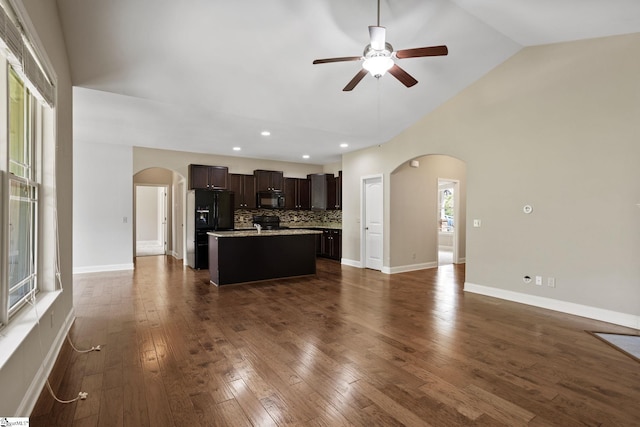 239 Applehill Way, Simpsonville, SC 29681 - unfurnished living room with arched walkways, a ceiling fan, recessed lighting, dark wood-type flooring, and high vaulted ceiling