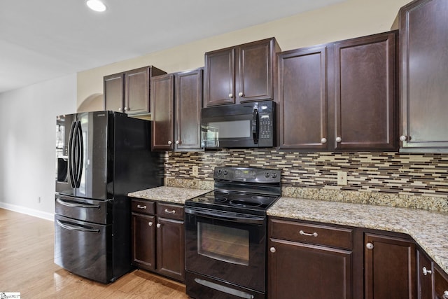 239 Applehill Way, Simpsonville, SC 29681 - kitchen with black appliances, dark brown cabinetry, and backsplash