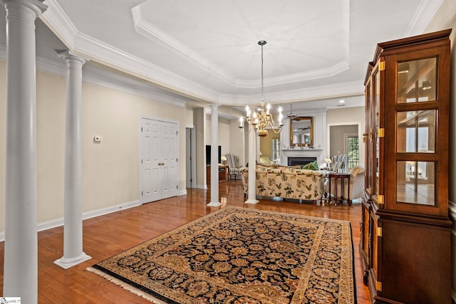 27 Grossmont Dr, Fountain Inn, SC 28644 - foyer with decorative columns, a tray ceiling, wood finished floors, crown molding, and a fireplace
