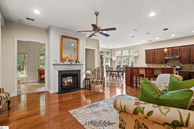 27 Grossmont Dr, Fountain Inn, SC 28644 - living area with recessed lighting, ceiling fan, a fireplace with flush hearth, wood finished floors, and baseboards