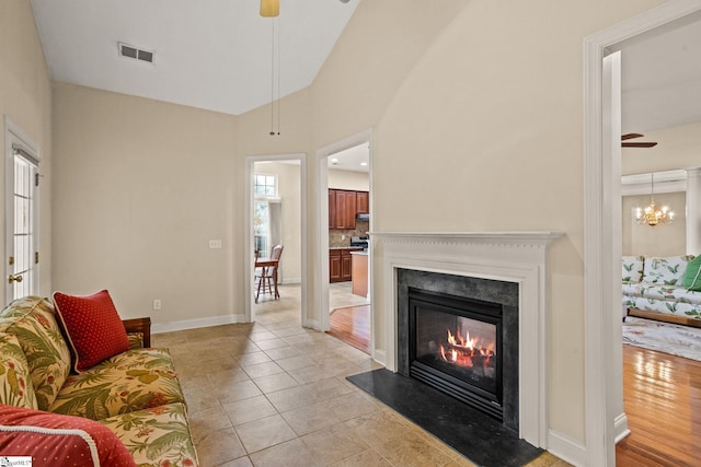 27 Grossmont Dr, Fountain Inn, SC 28644 - living room with ceiling fan, a glass covered fireplace, plenty of natural light, baseboards, and lofted ceiling