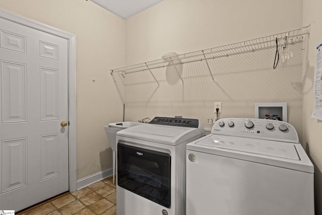 27 Grossmont Dr, Fountain Inn, SC 28644 - laundry area with washing machine and dryer, baseboards, and light stone finish floors