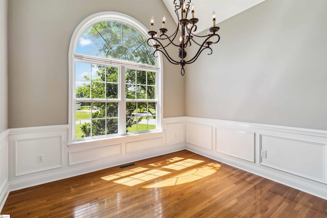 1073 Corie Crest Dr, Boiling Springs, SC 29316 - unfurnished dining area with a chandelier, wainscoting, healthy amount of natural light, light wood finished floors, and a decorative wall