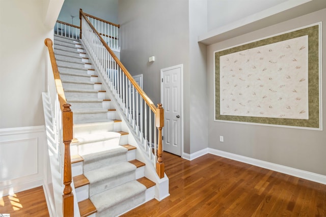 1073 Corie Crest Dr, Boiling Springs, SC 29316 - stairway featuring wood finished floors, baseboards, and a high ceiling