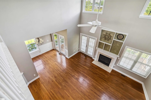 1073 Corie Crest Dr, Boiling Springs, SC 29316 - unfurnished living room with a high ceiling, plenty of natural light, wood finished floors, a chandelier, and a tile fireplace