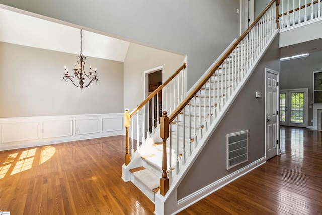 1073 Corie Crest Dr, Boiling Springs, SC 29316 - staircase with hardwood / wood-style flooring, a chandelier, and high vaulted ceiling