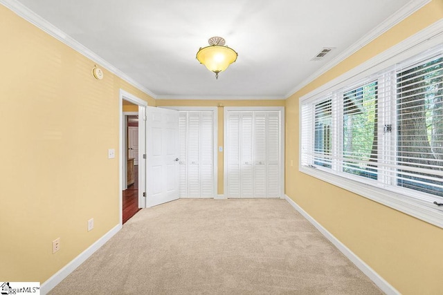 511 Shorecrest Dr, Clemson, SC 29631 - unfurnished bedroom featuring ornamental molding, baseboards, carpet, and multiple closets