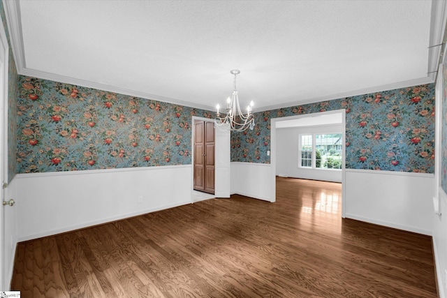 302 Spruce St, Clinton, SC 29325 - unfurnished room with wainscoting, a chandelier, wood finished floors, crown molding, and wallpapered walls