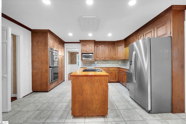 302 Spruce St, Clinton, SC 29325 - kitchen with black appliances, a kitchen island, tasteful backsplash, recessed lighting, and wooden counters
