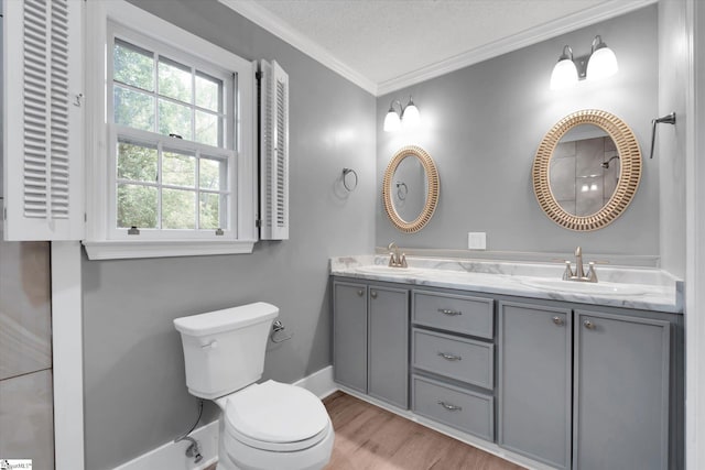 302 Spruce St, Clinton, SC 29325 - bathroom with double vanity, crown molding, toilet, wood finished floors, and a textured ceiling