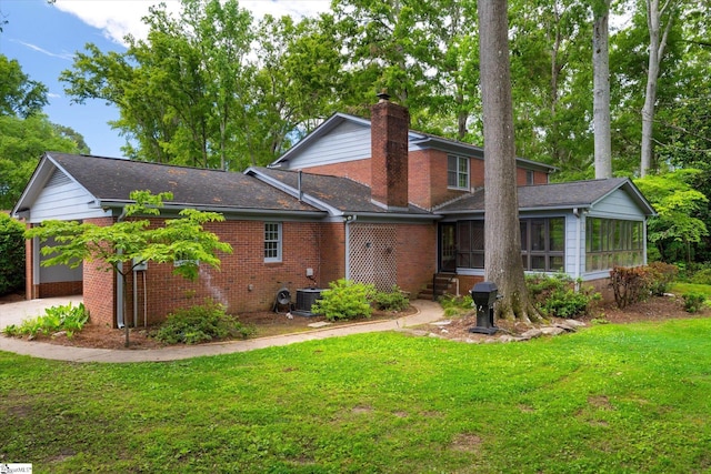 302 Spruce St, Clinton, SC 29325 - back of property featuring a sunroom, brick siding, a chimney, a yard, and central air condition unit